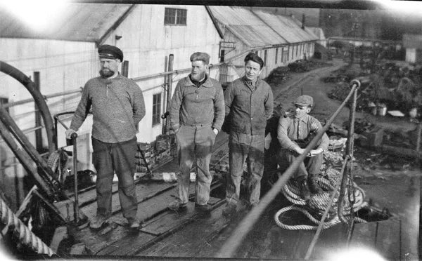 Sailors beside a pier. Hans is second from the right; the handrail is in front of his left foot. Identification supplied by the family. Vessel, location and date remain unconfirmed.
