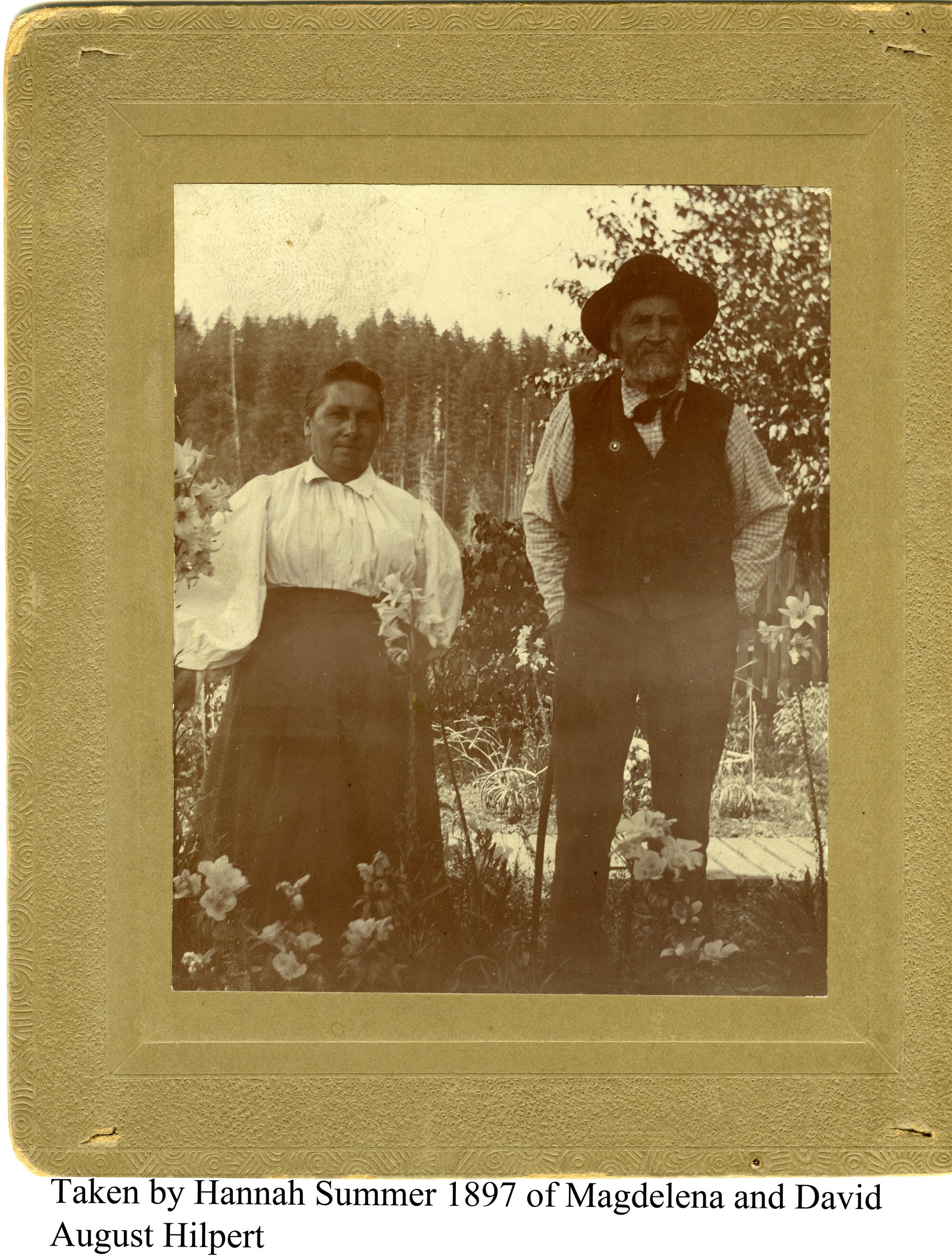 Magdalena and David August Hilpert standing among flowers, within the photograph’s original decorative mount